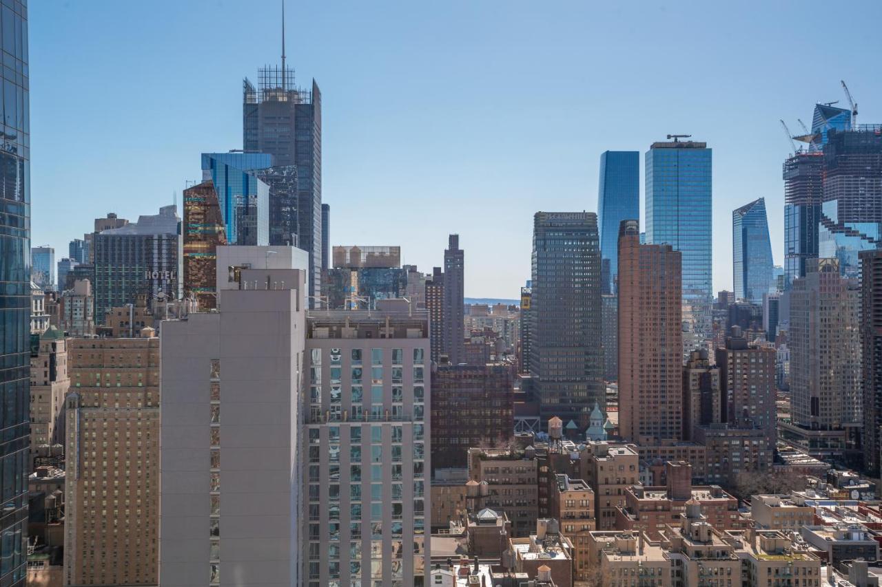 A city skyline with many skyscrapers and a clear blue sky.