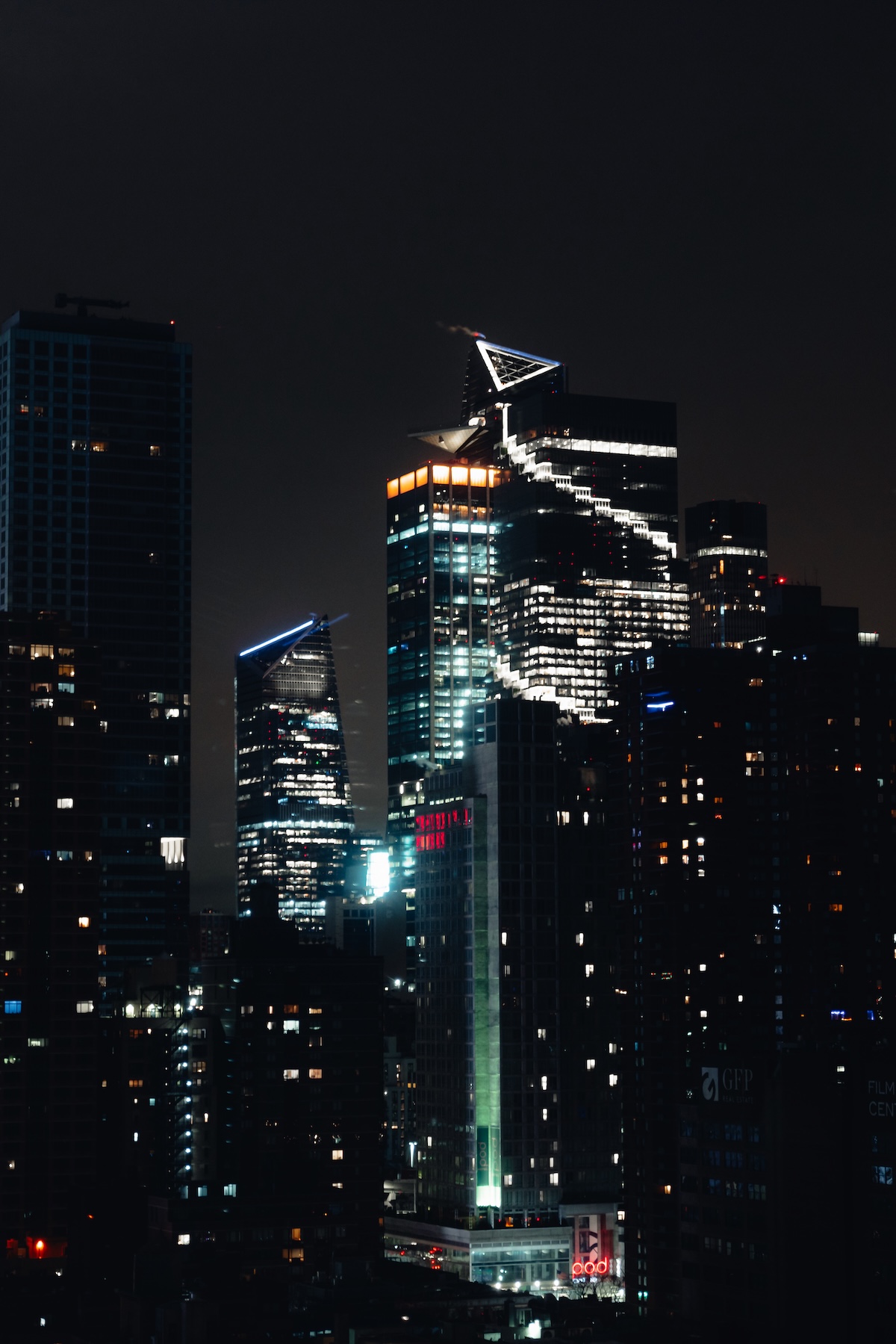 A nighttime cityscape with many skyscrapers and bright lights