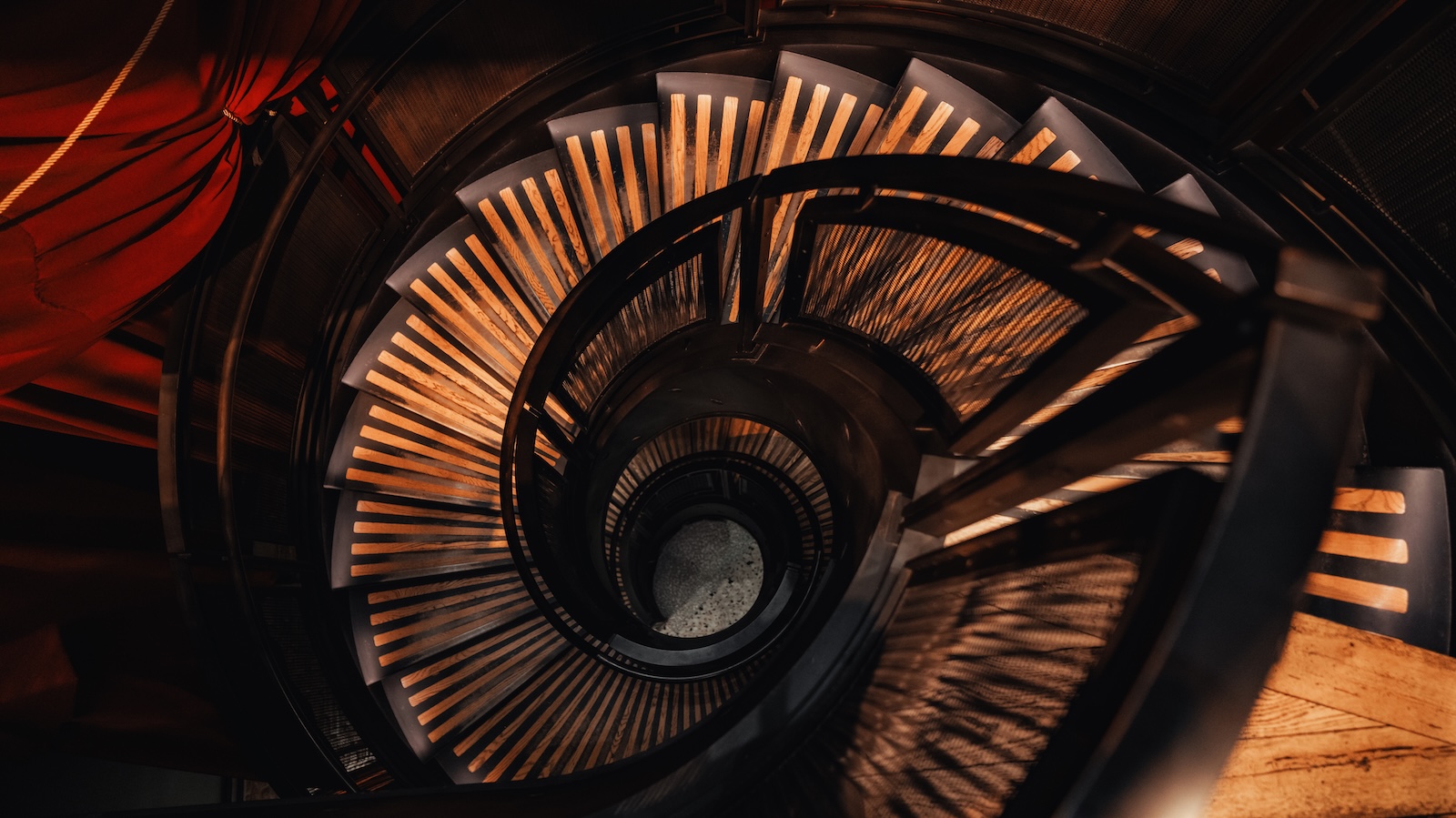 a spiral staircase with wooden and metal construction
