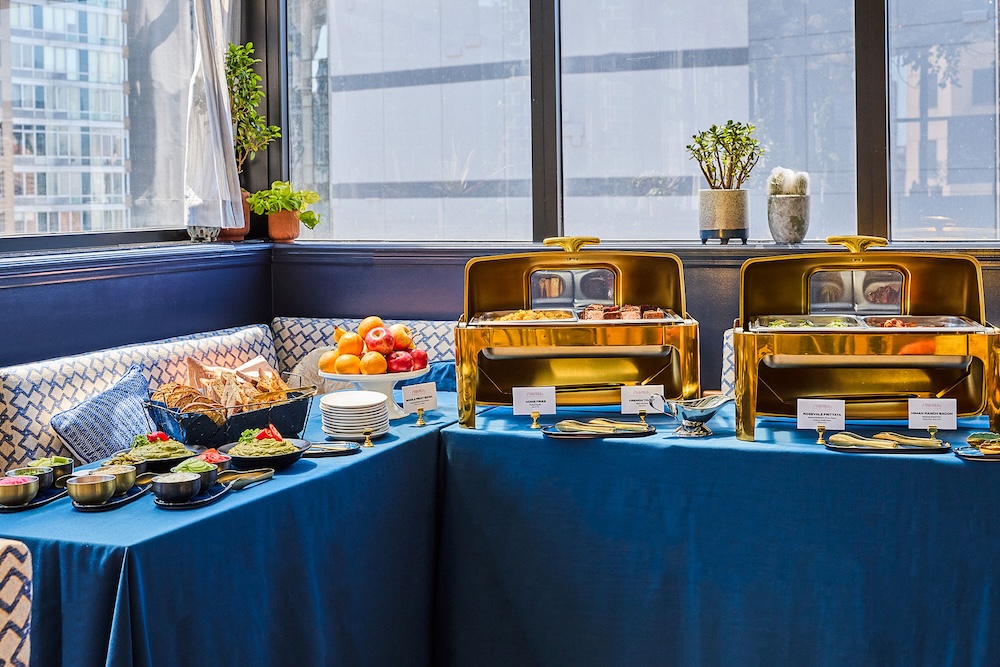 A buffet table with a city view