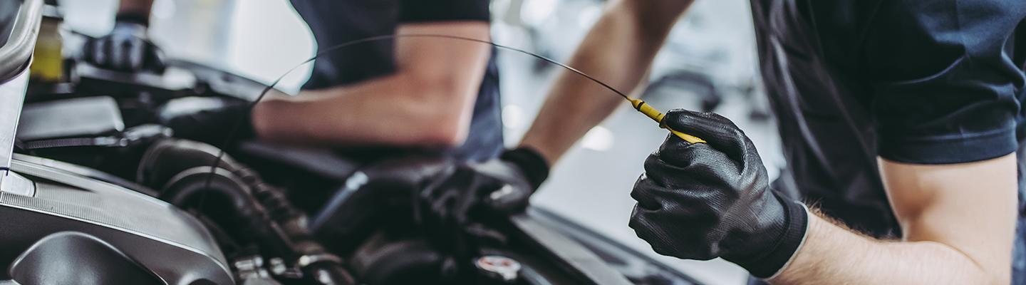 Service tech checking oil