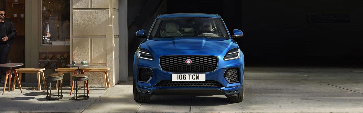 Blue 2022 Jaguar E-PACE front view parked by cafe