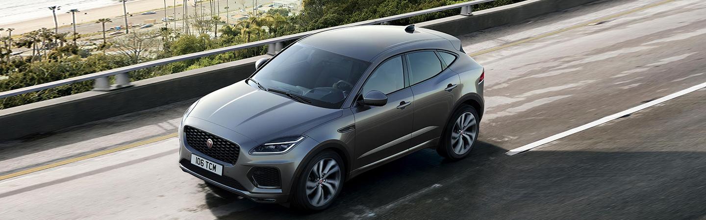 Silver 2022 Jaguar E-PACE view from above driving on seashore road