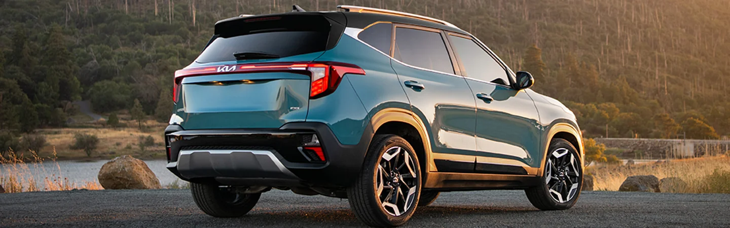 Back view of a parked 2025 Kia Seltos Denim parked by a lake