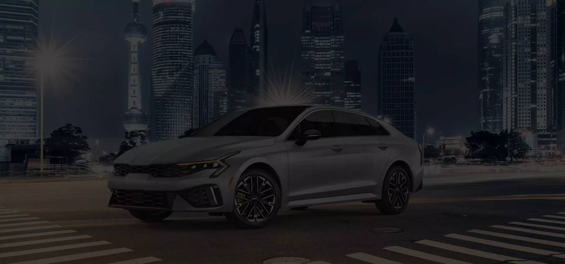 Kia car driving down the street in a city