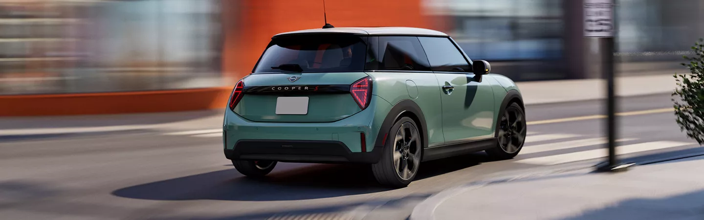 Rear view of the 2026 MINI Cooper 2-Door driving through the city