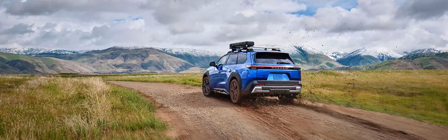 Rear view of 2026 Subaru Trailseeker driving on a dirt mountain road in Tyler, Texas