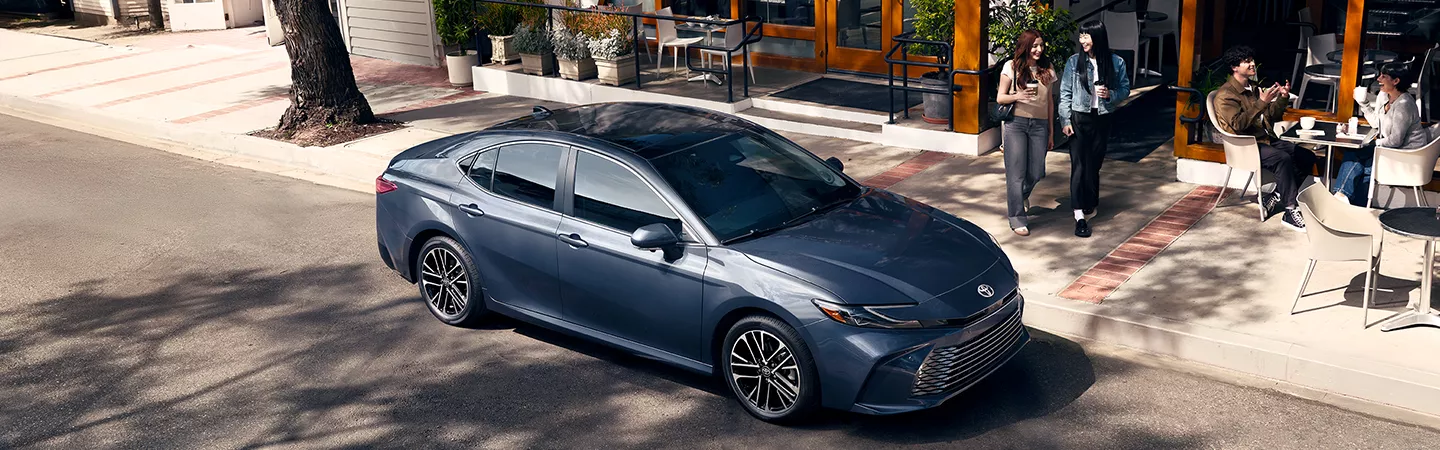 2026 Toyota Camry parked in front of a cafe in the city in the daytime