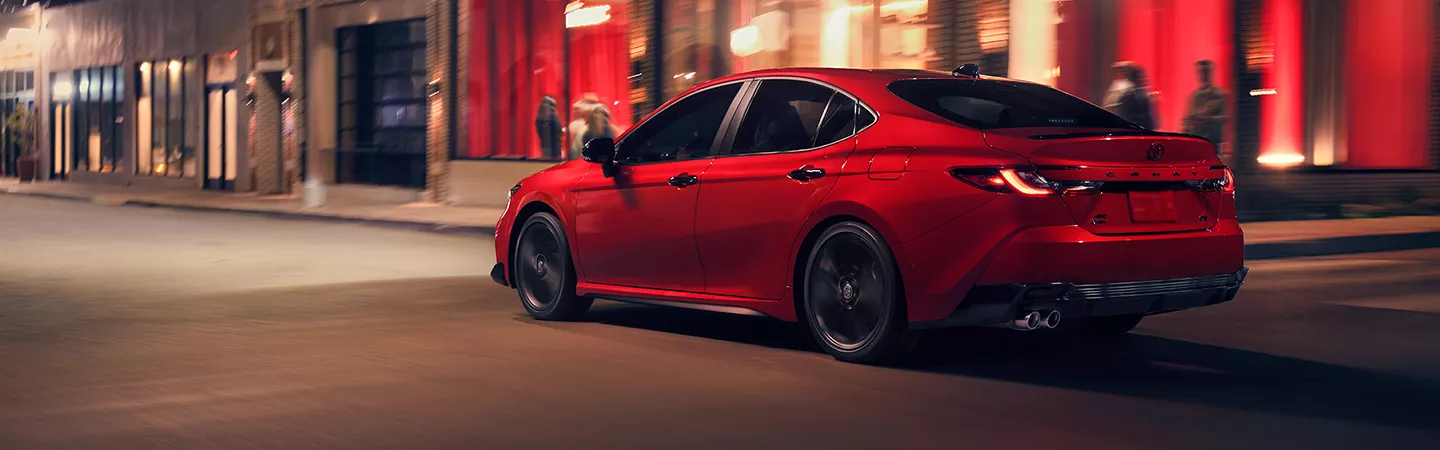 2026 Toyota Camry driving through the city at night