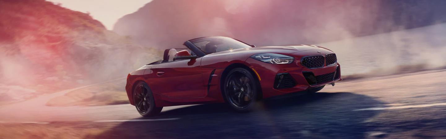 Red 2022 BMW Z4 driving on a road
