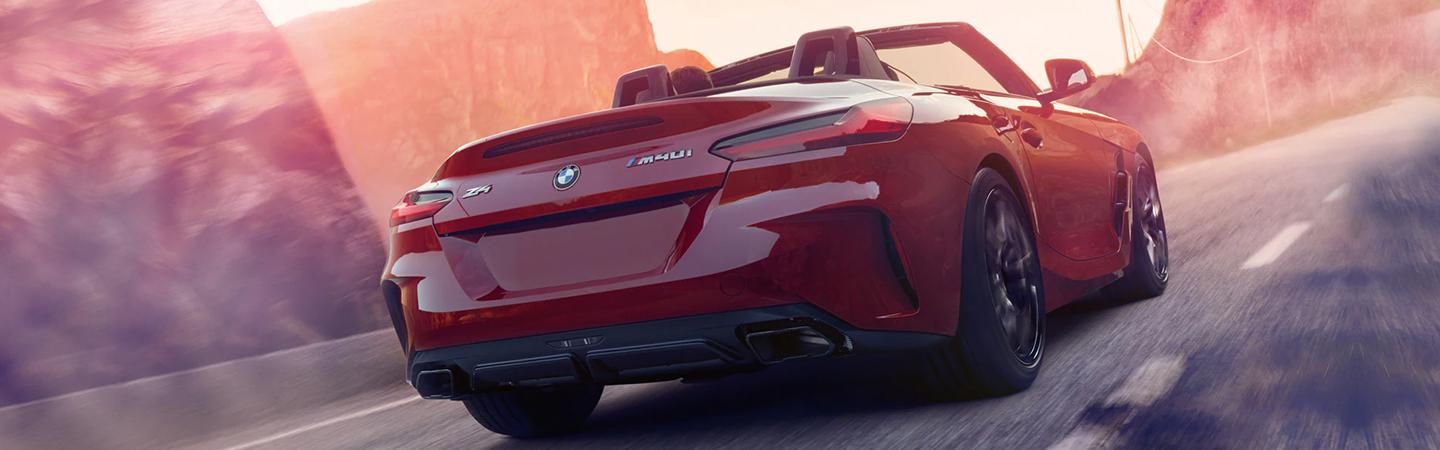 Red 2022 BMW Z4 driving on a road