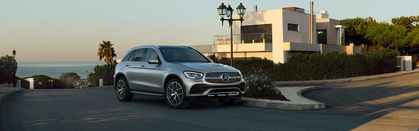 Gray 2022 Mercedes-Benz GLC parked by some houses