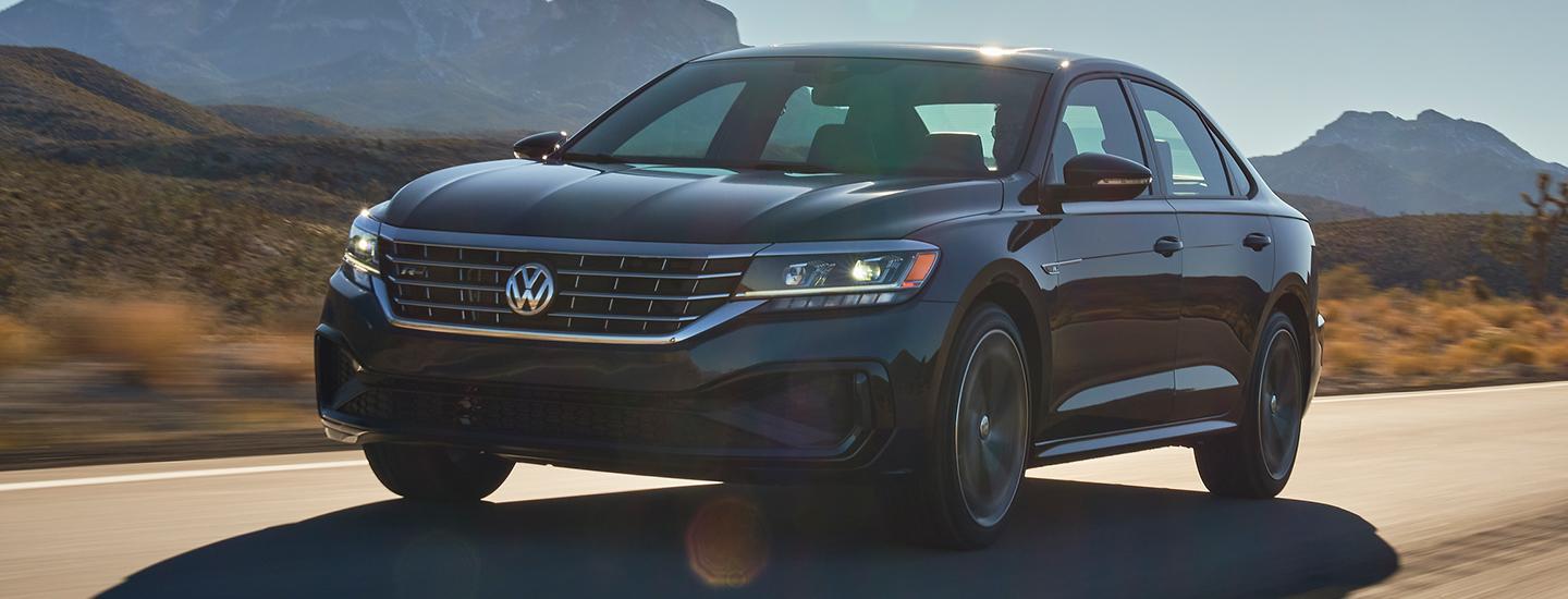 Black 2022 Volkswagen Passat driving on the road