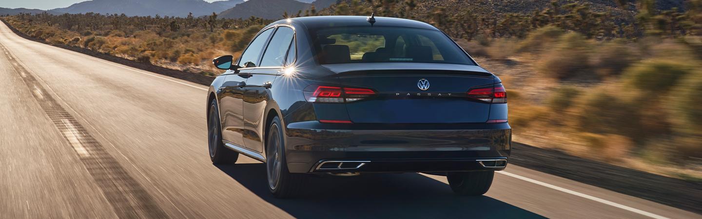 Back view of a 2022 Volkswagen Passat driving on the road