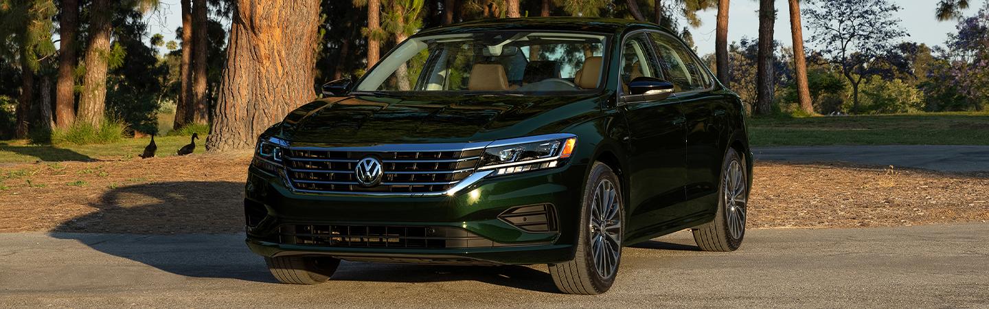 Green 2022 Volkswagen Passat parked by some trees