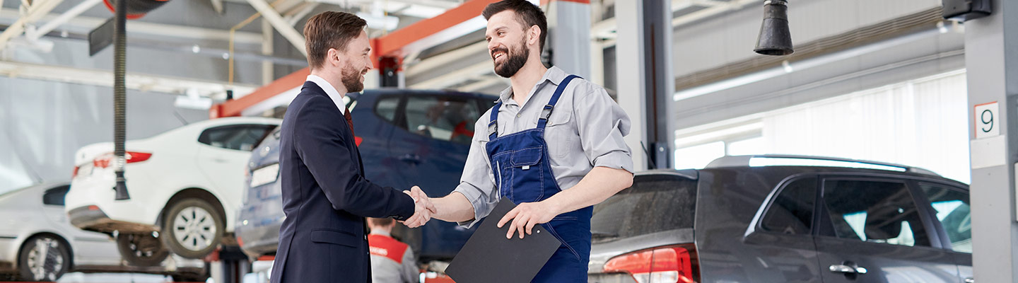tech and customer shaking hands and smiling