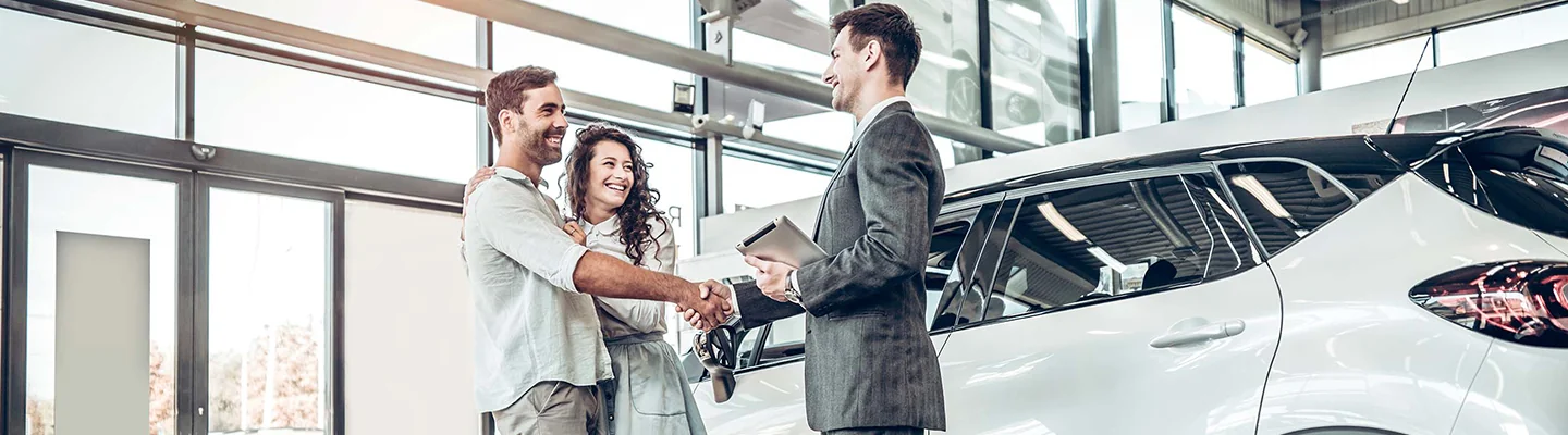 Sales person shaking hand of customers
