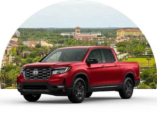 Honda ridgeline parked in front of cityscape