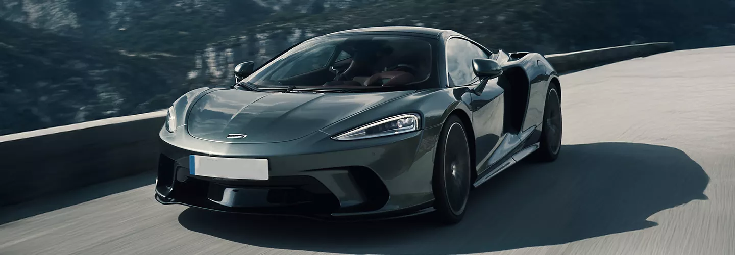 exotic car driving down a city street