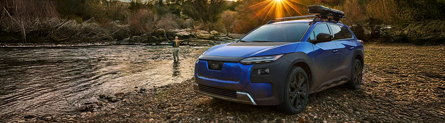 2026 Subaru Trailseeker parked near a body of water with a fisherman and a sunset in the background in Tyler, TX
