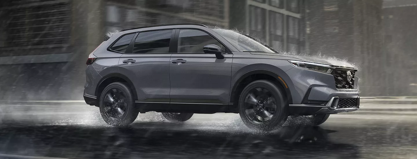 2026 Honda CR-V driving through the city in the rain