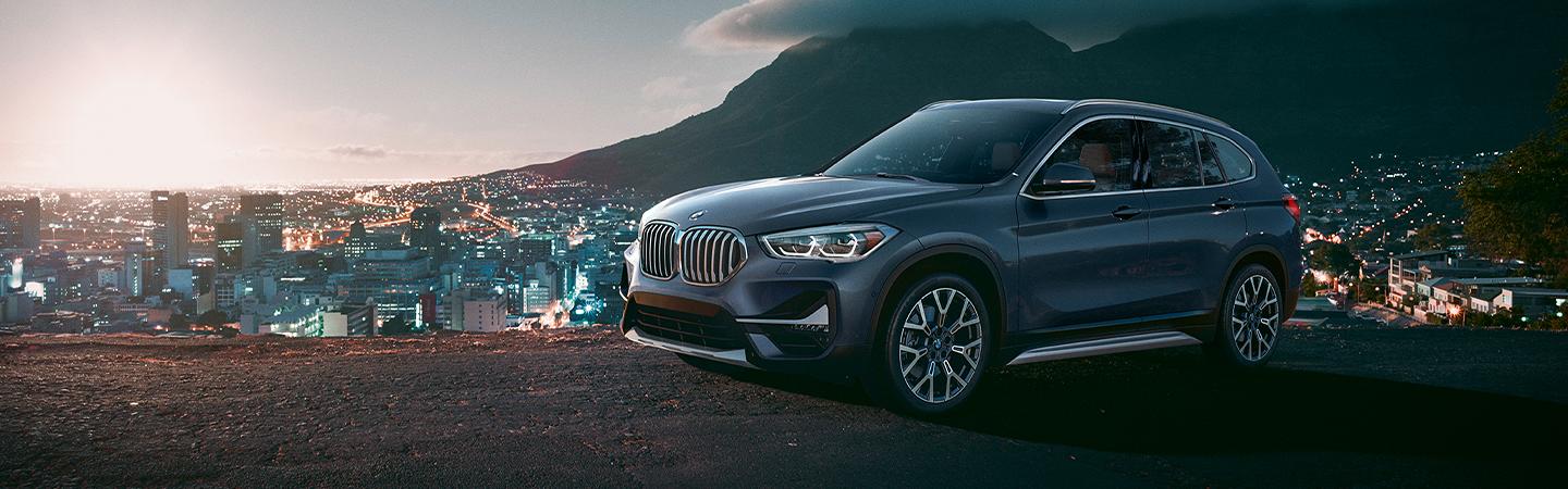 BMW X1 parked overlooking the city