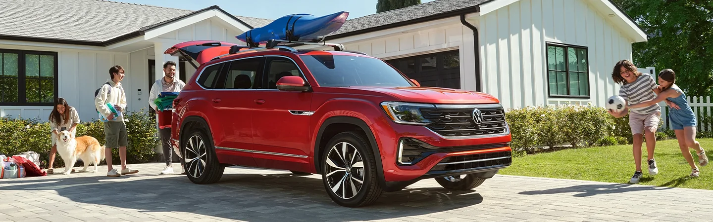 2025 Volkswagen Atlas SE parked at home being loaded by a family