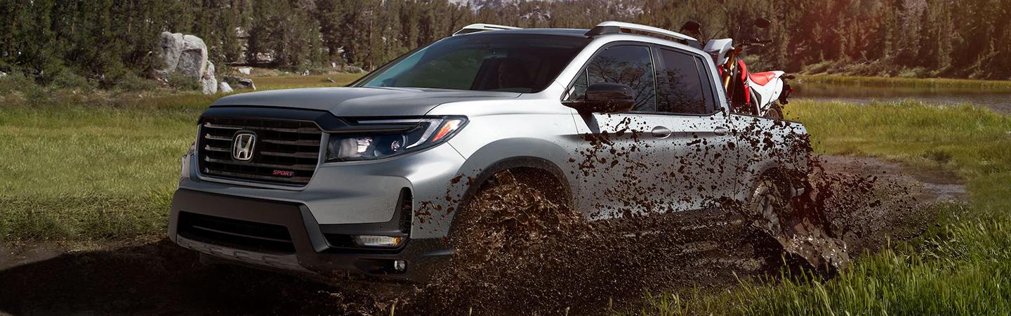 silver 2022 Honda Ridgeline going through muddy water