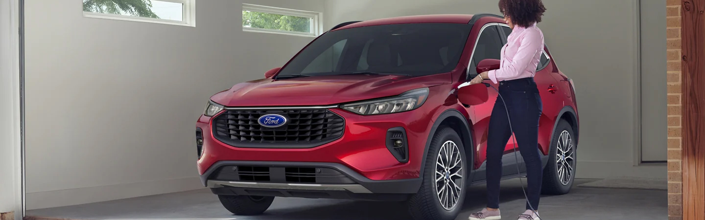 2023 Ford Escape parked in garage with woman at the door