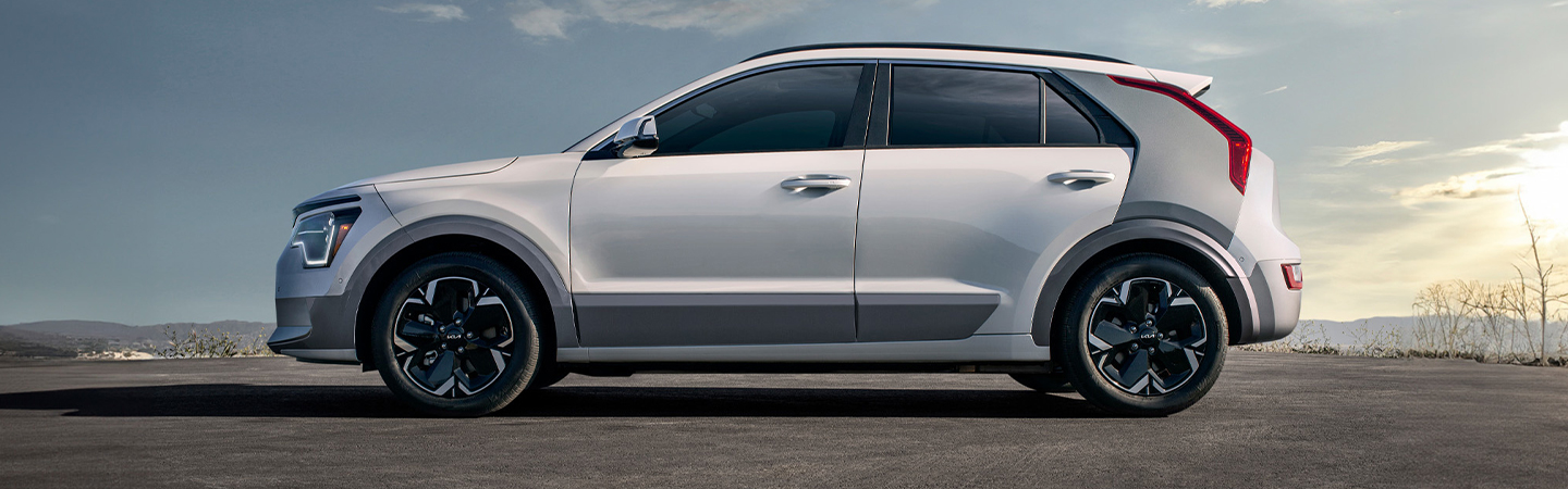 2024 Kia Niro EV vs 2024 Kia EV9 side front in white