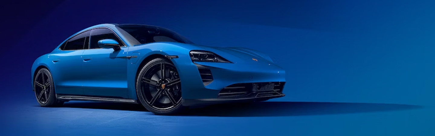 2024 Porsche Taycan vs 2024 Porsche Cayenne front side in blue