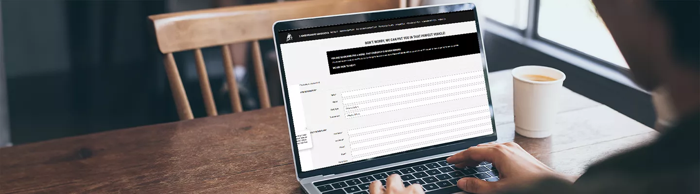 Person on a laptop looking at lamborghinisarasota.com