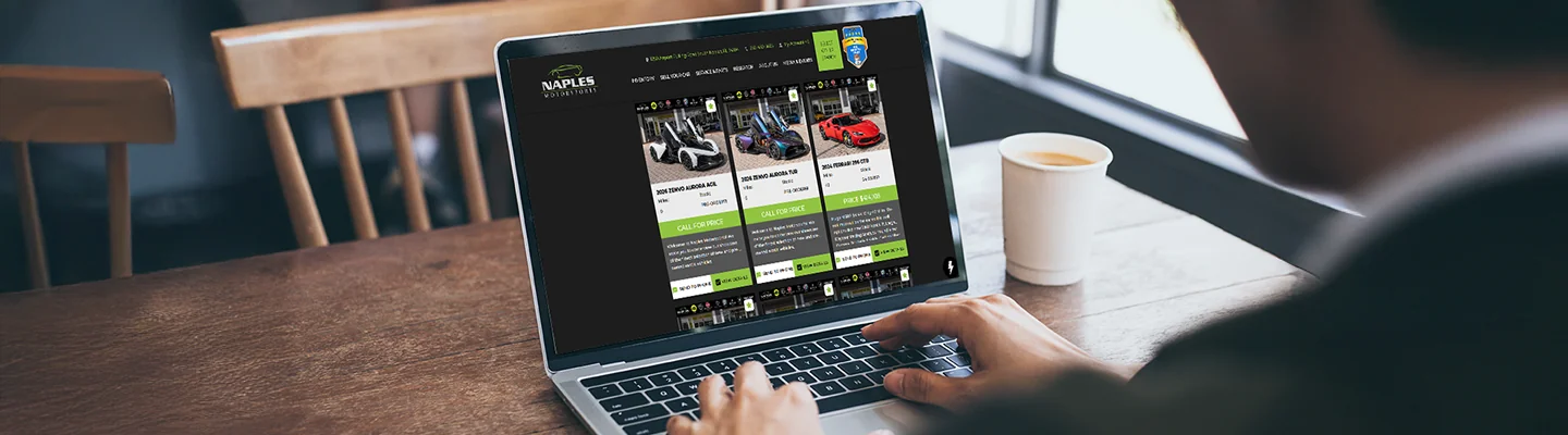 a view of a person's hands typing on a laptop shopping online at Naples Motorsports