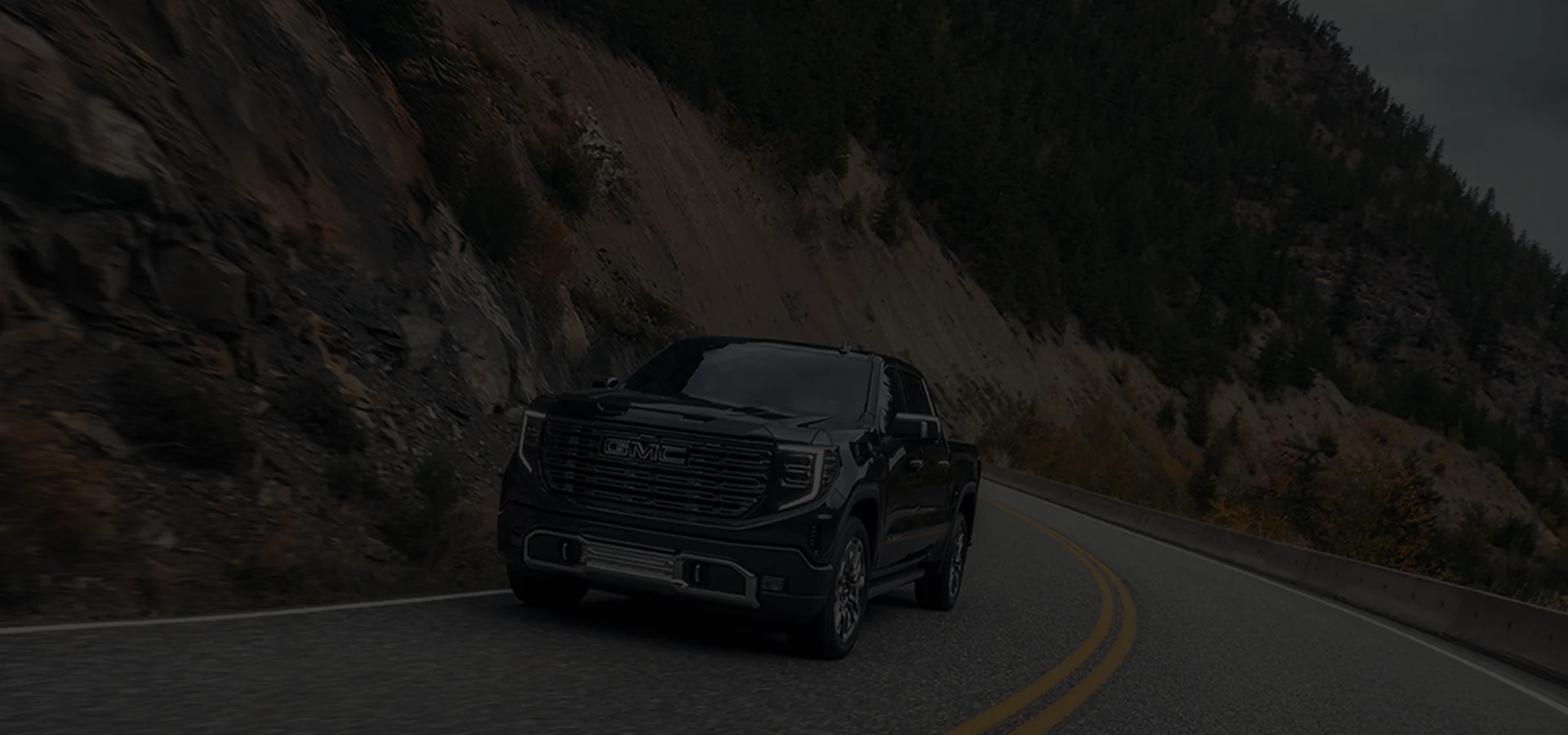 GMC on a turn in background