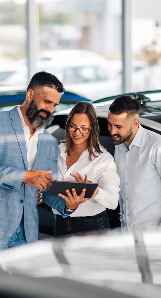 couple working with car salesperson to find the perfect car