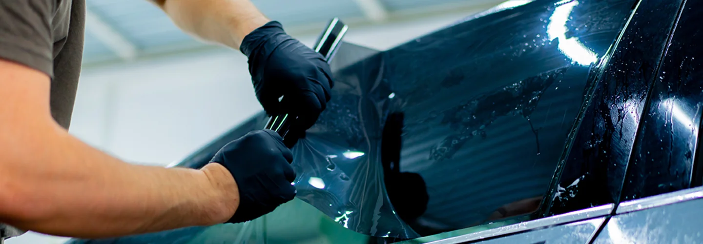 Service tech applying a window tint