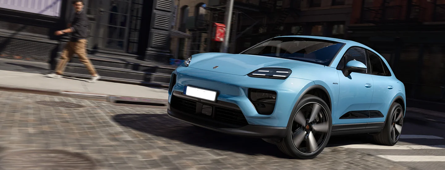 front view of a light blue 2025 Porsche Macan Electric