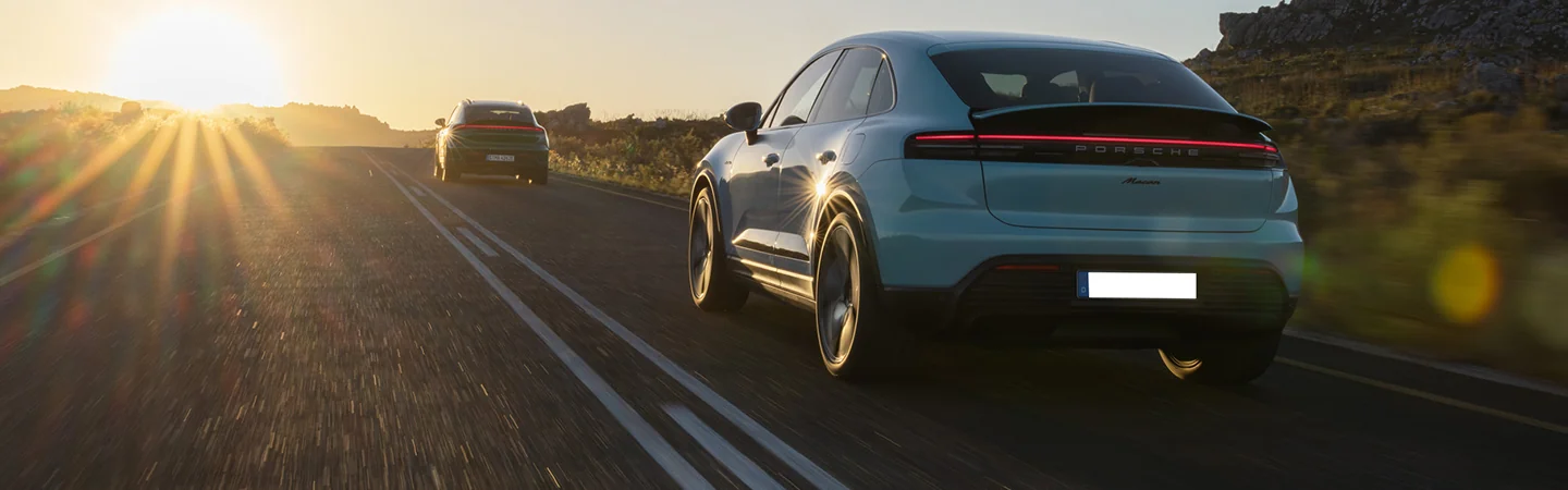 2025 Porsche Macan Electric driving into the sunset