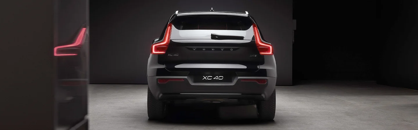 Back view of a parked black 2025 Volvo XC40