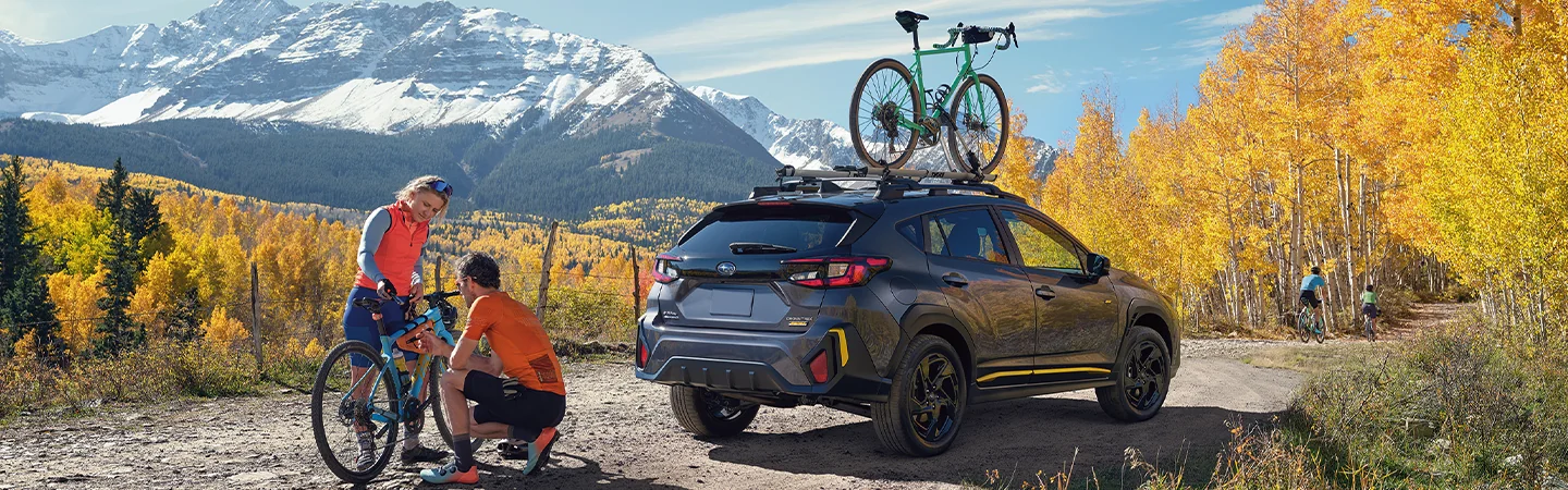 2025 Subaru Crosstrek parked at top of a hill with people having bicycles in Waco, TX