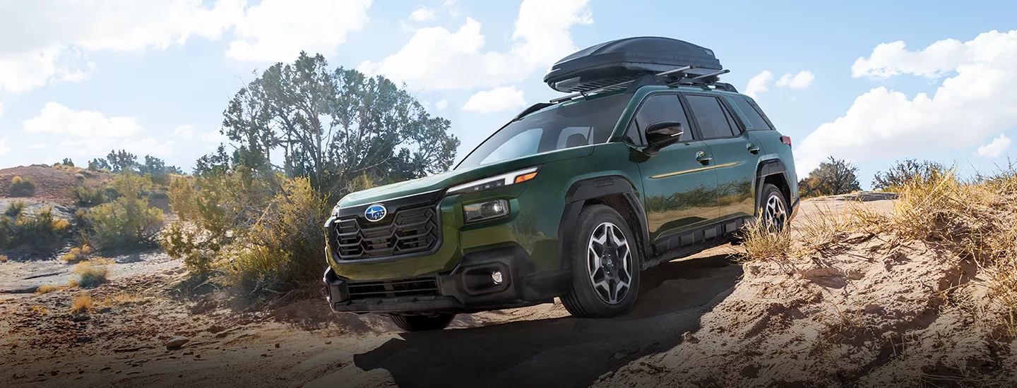 2026 Subaru Outback driving down over a desert mountain road