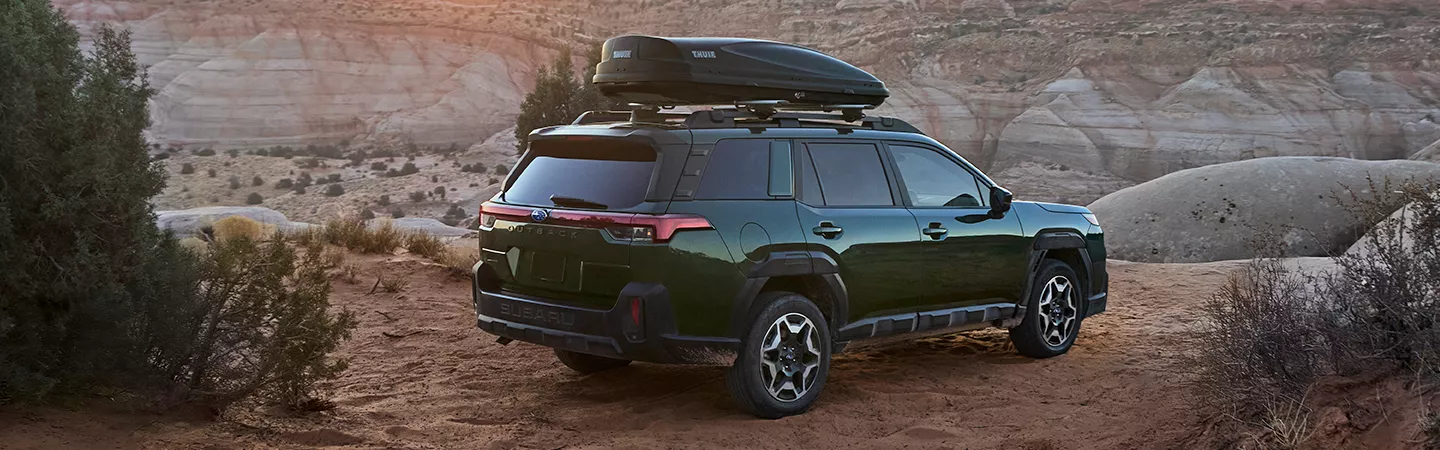2026 Subaru Outback parked at a desert mountain overlook at dusk