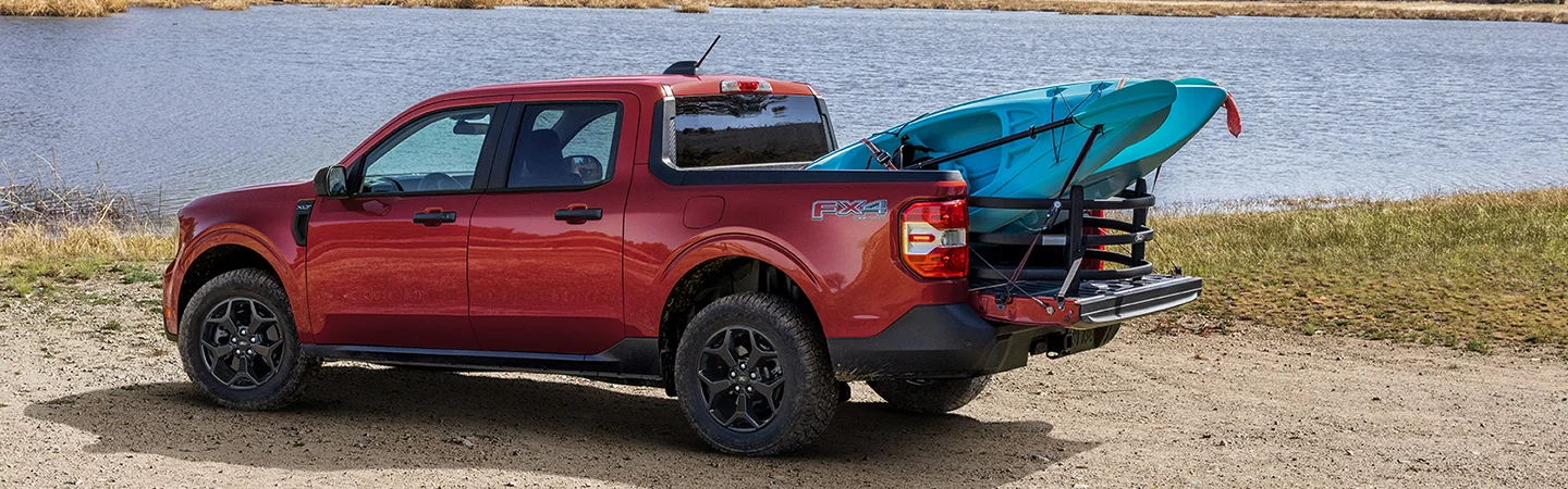 a red 2026 Ford Maverick XL loaded with kayaks in back