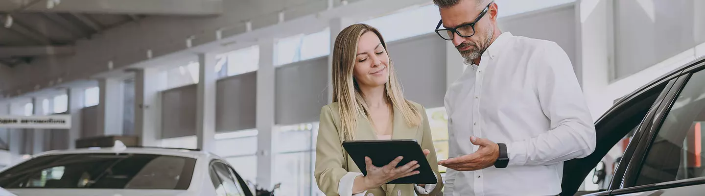man explaining to woman the details on a tablet