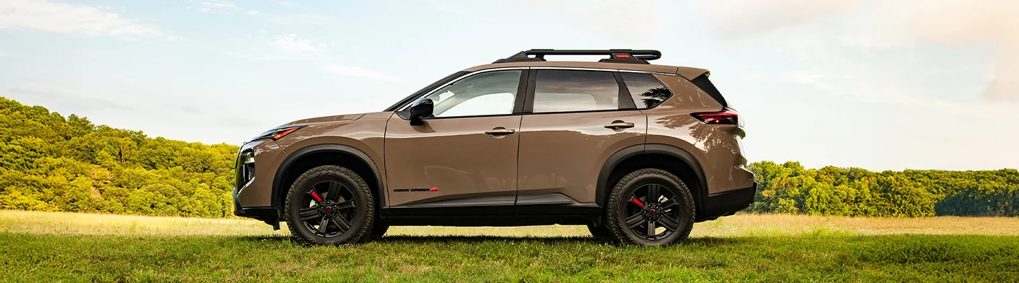 drivers side view of a brown 2026 Nissan Rogue