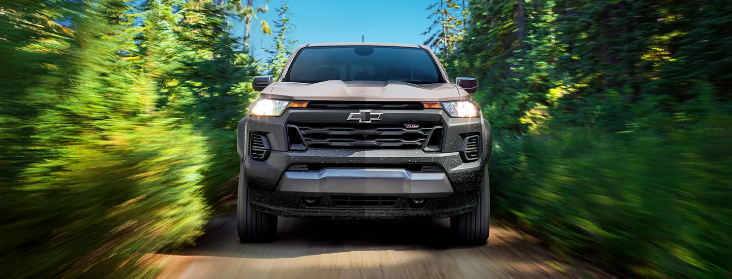 direct front view of a 2026 Chevrolet Colorado in motion driving through narrow lane