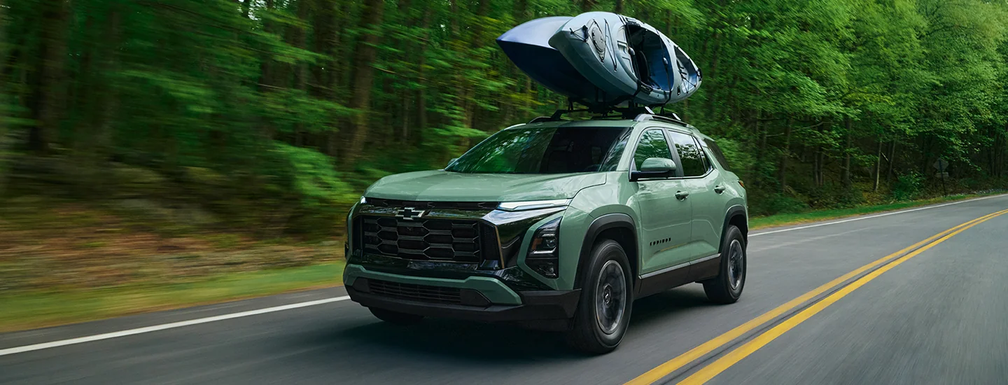 a green 2026 Chevrolet Equinox with a kayak on rack on top
