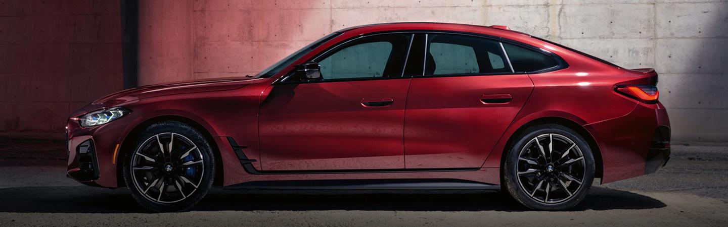 view of a side view of a red BMW 4 Series parked