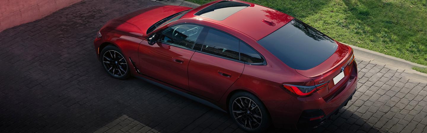 Red BMW 4 Series parekd in the drive way