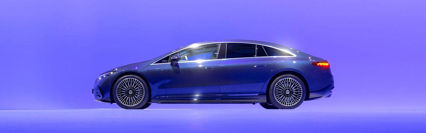 Side view of a 2022 Mercedes-Benz EQS-Class light up blue